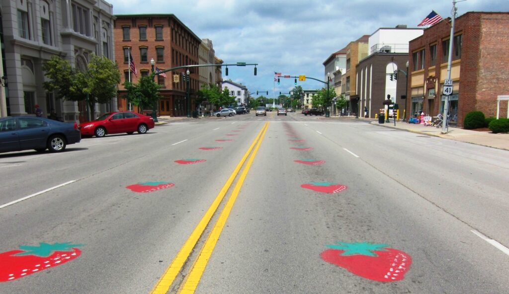 Strawberries in the road; Downtown Troy Ohio street with strawberries painted onto the pavement; photo by Art Anderson